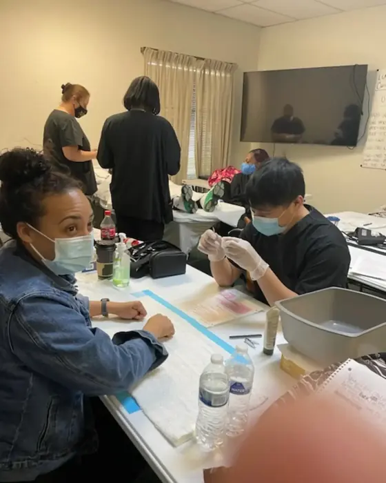 Students practicing clinical skills at the training tables